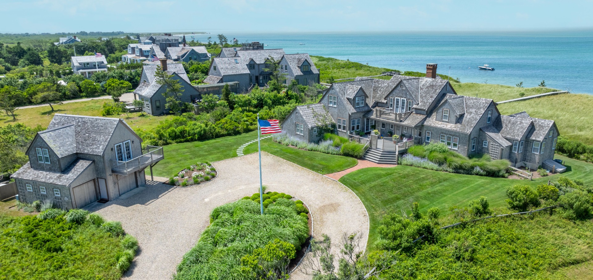 an aerial view of a house with garden space and ocean view