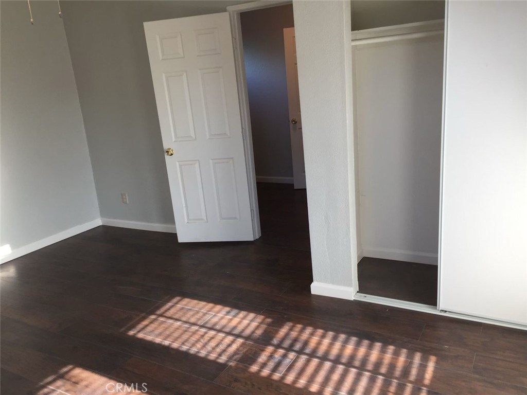 an empty room with wooden floor