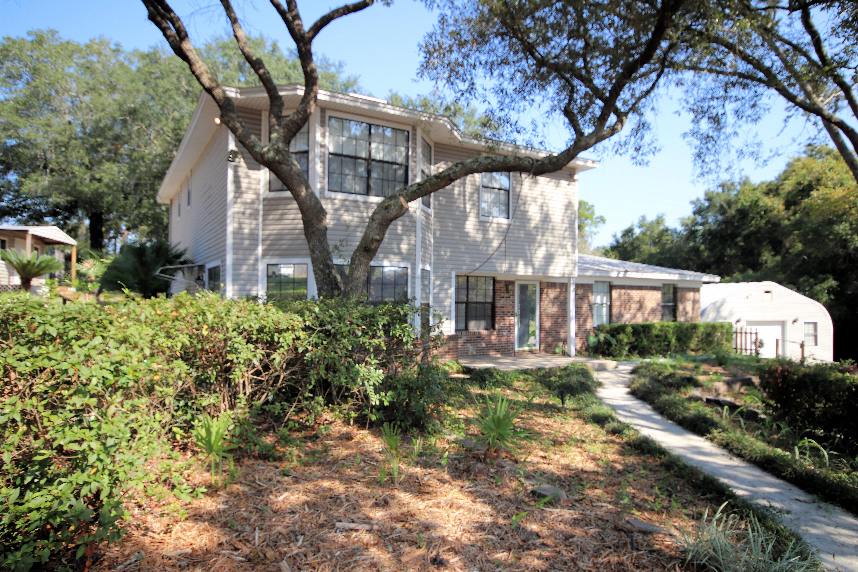 a front view of a house with a yard and fountain