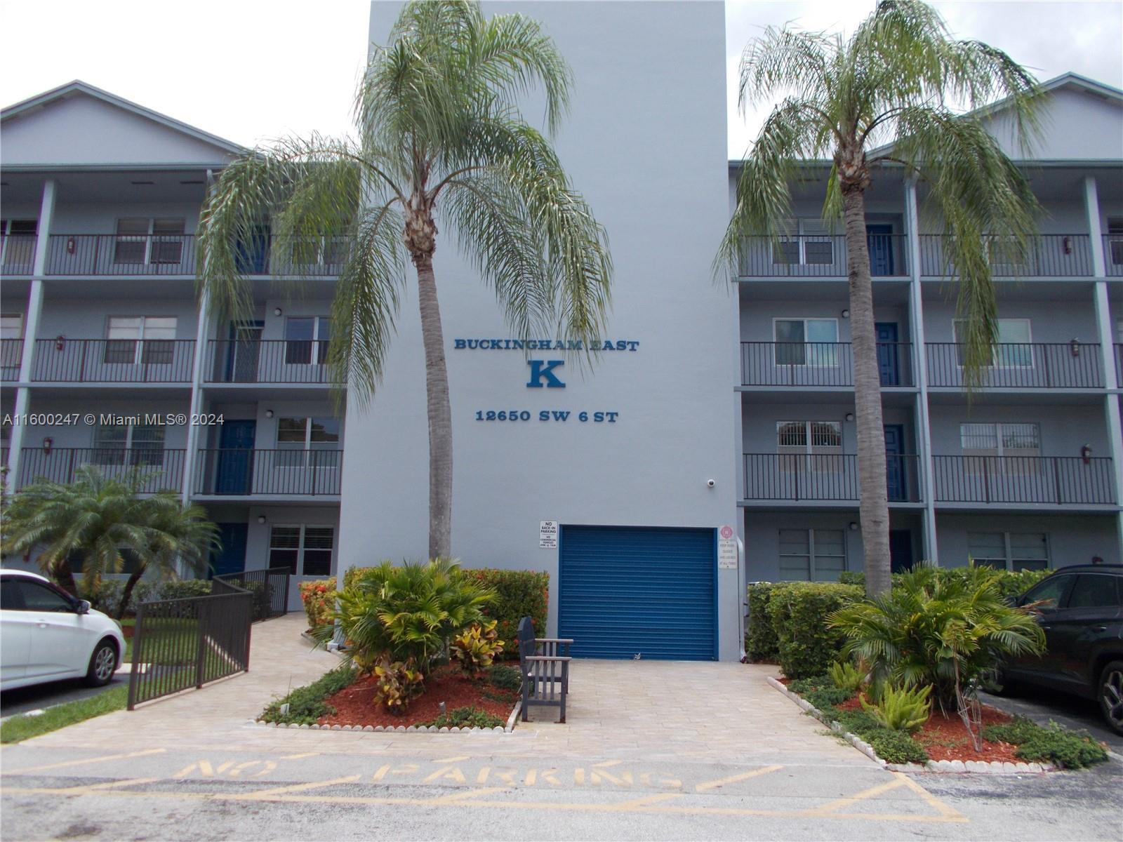 a front view of a building with garden