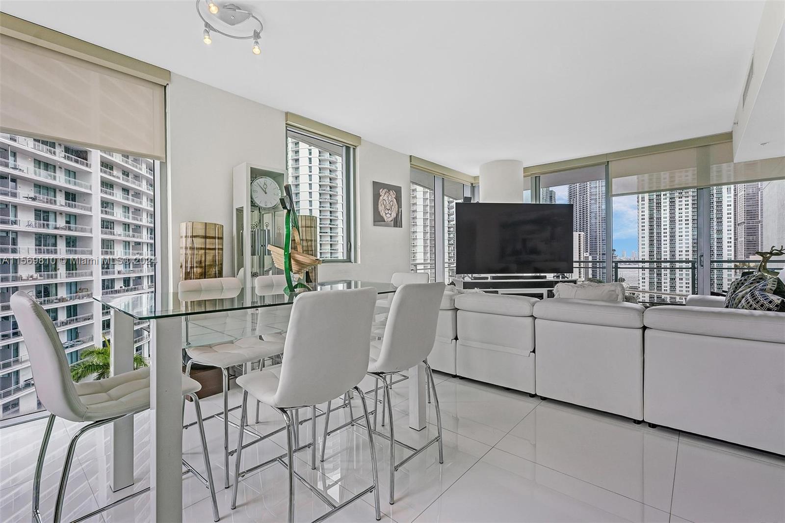 a kitchen with stainless steel appliances furniture and a flat screen tv