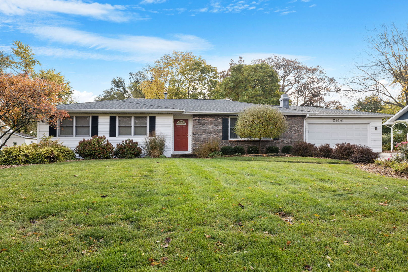 a front view of house with yard and green space