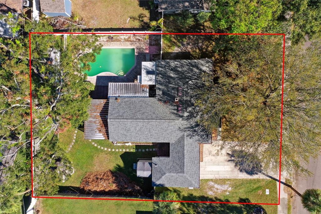 an aerial view of a house with a yard basket ball court and outdoor seating