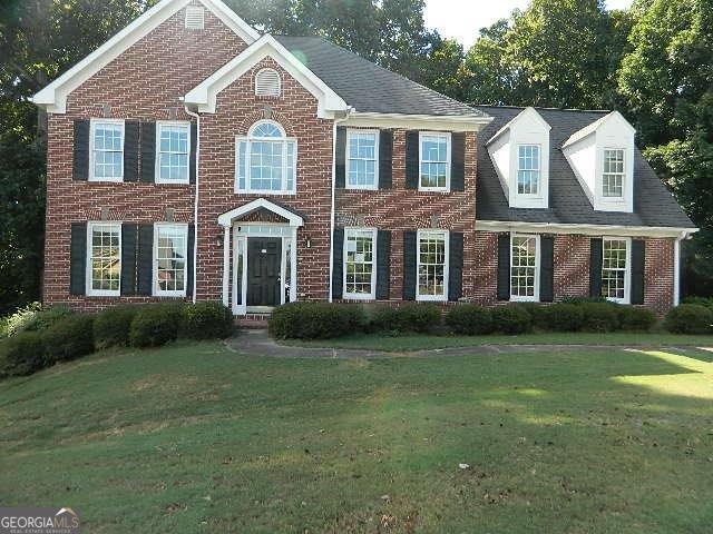 a front view of a house with a garden