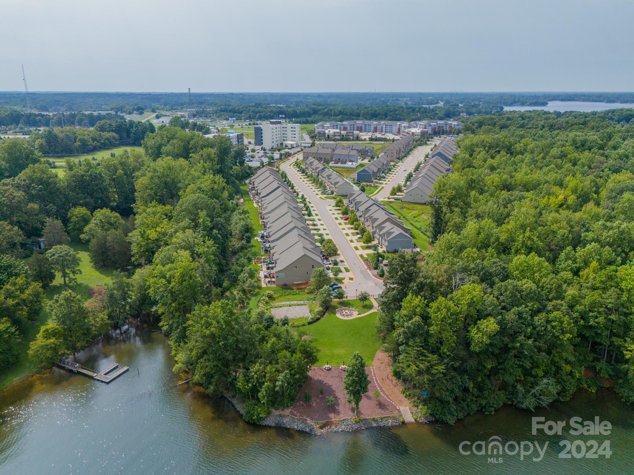 an aerial view of a house with a yard and lake view