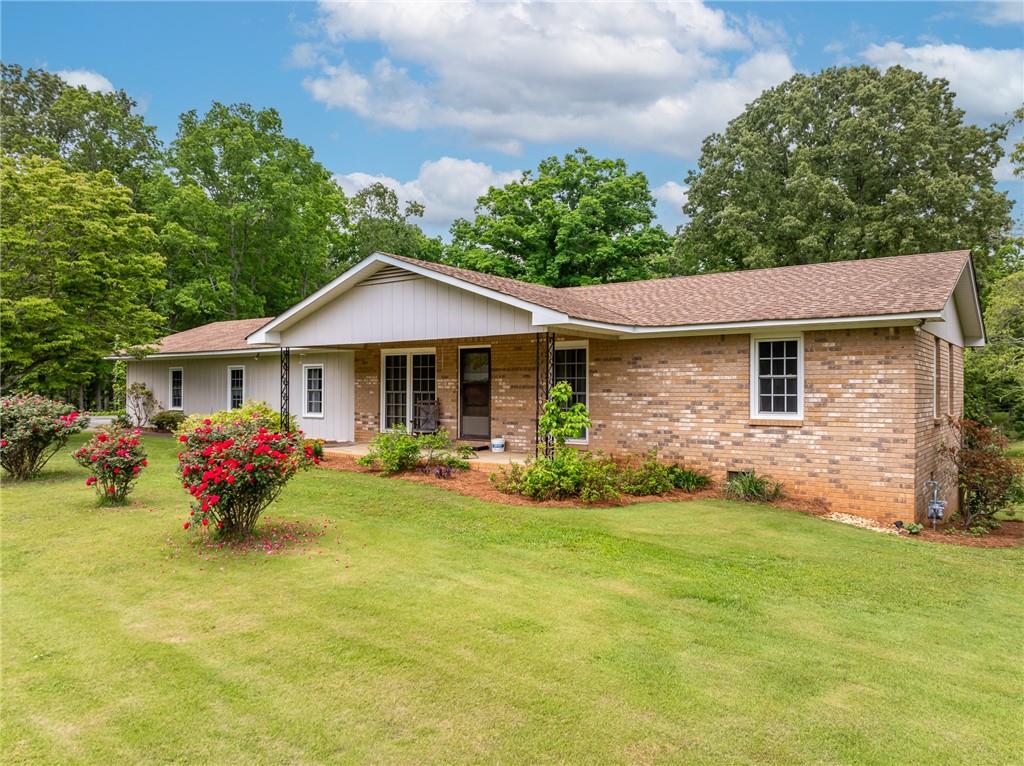 a front view of a house with yard and porch