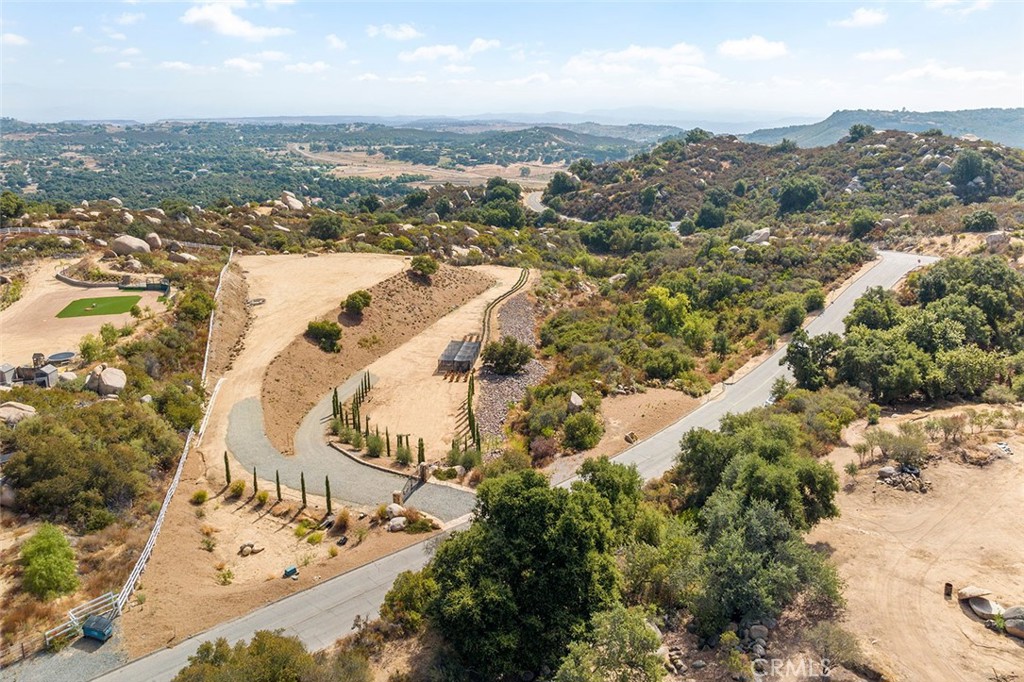 an aerial view of a house with a mountain