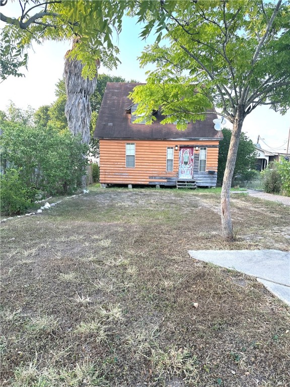 a backyard of a house with table and chairs