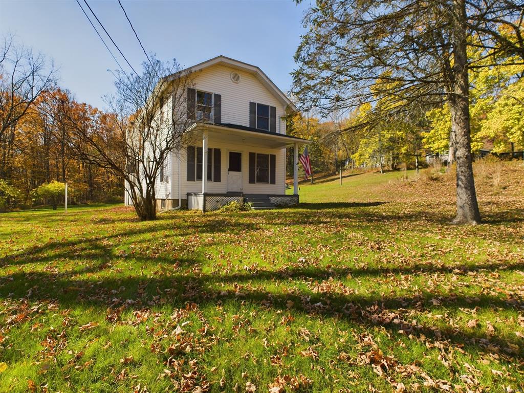 a front view of a house with a yard