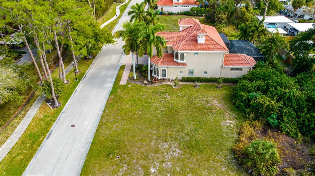 an aerial view of residential houses with yard