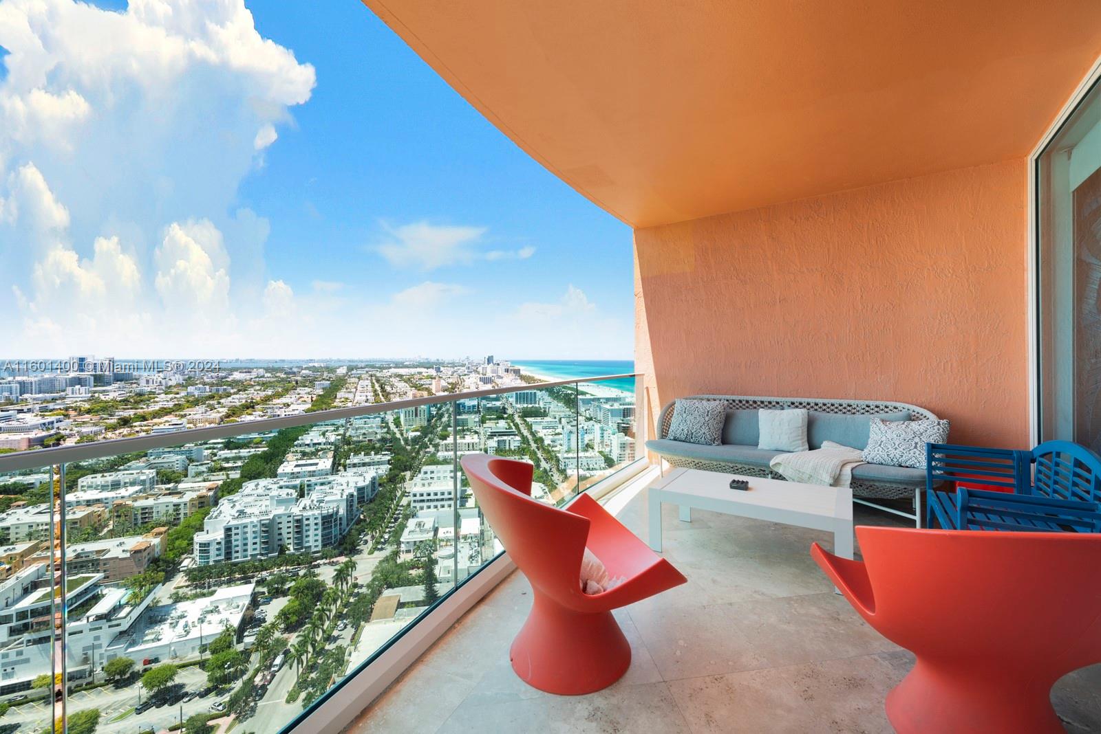 an outdoor sitting area with a view of city from a balcony