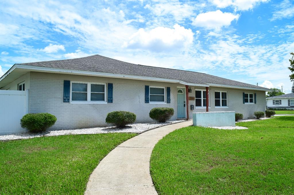 a front view of house with yard and green space