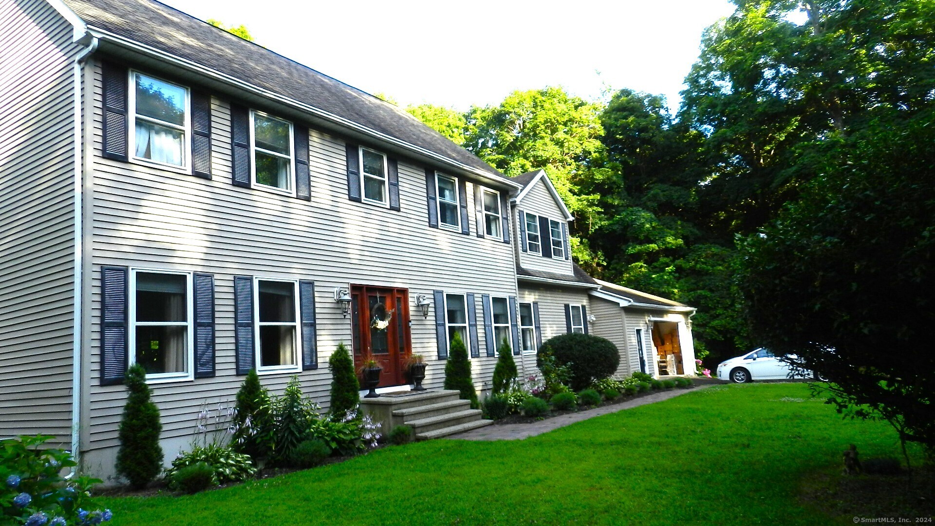 a front view of a house with a yard and porch