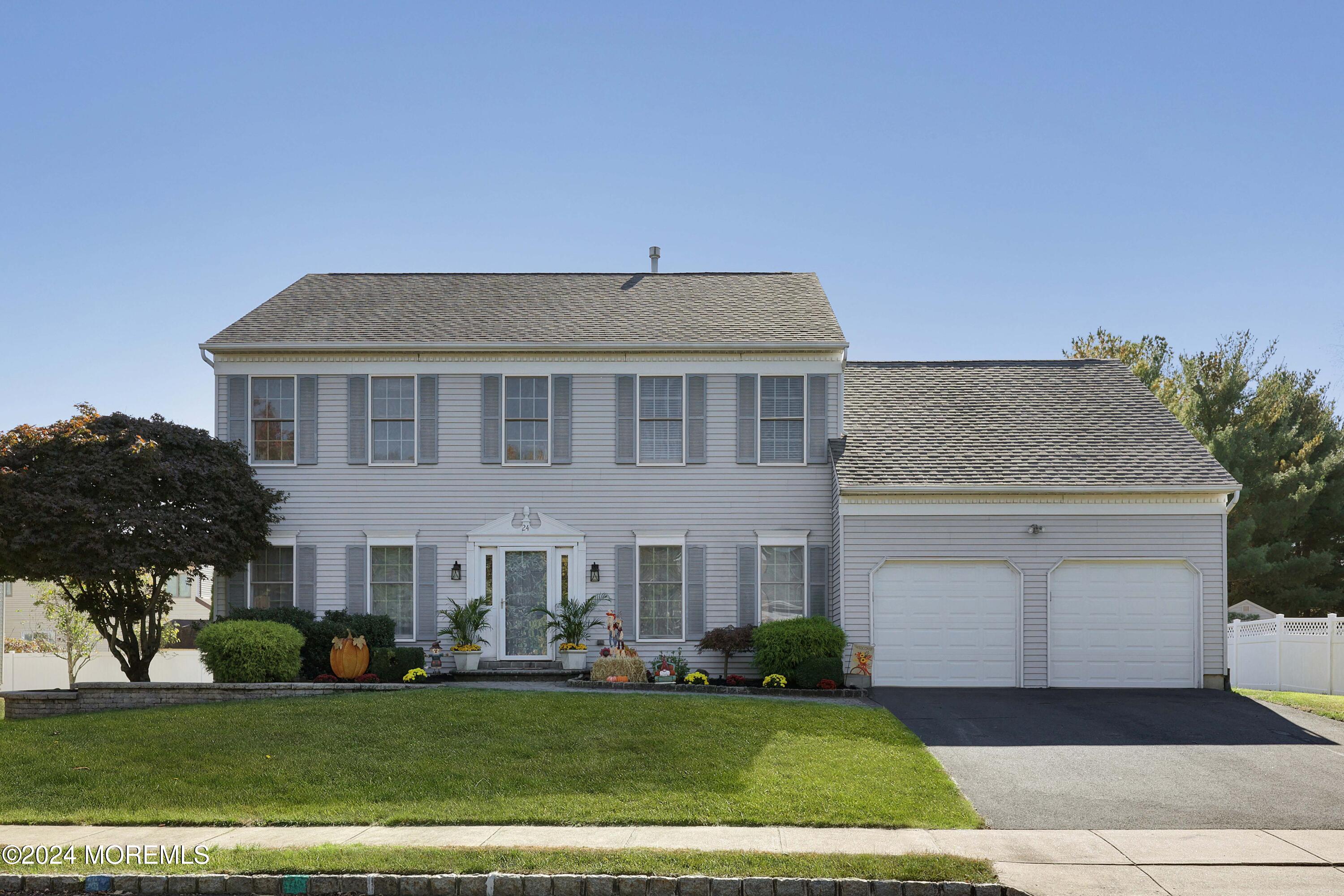 a front view of a house with a garden