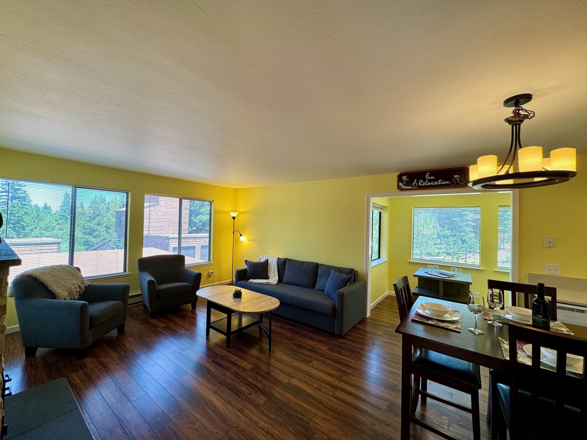 a living room with furniture and a floor to ceiling window