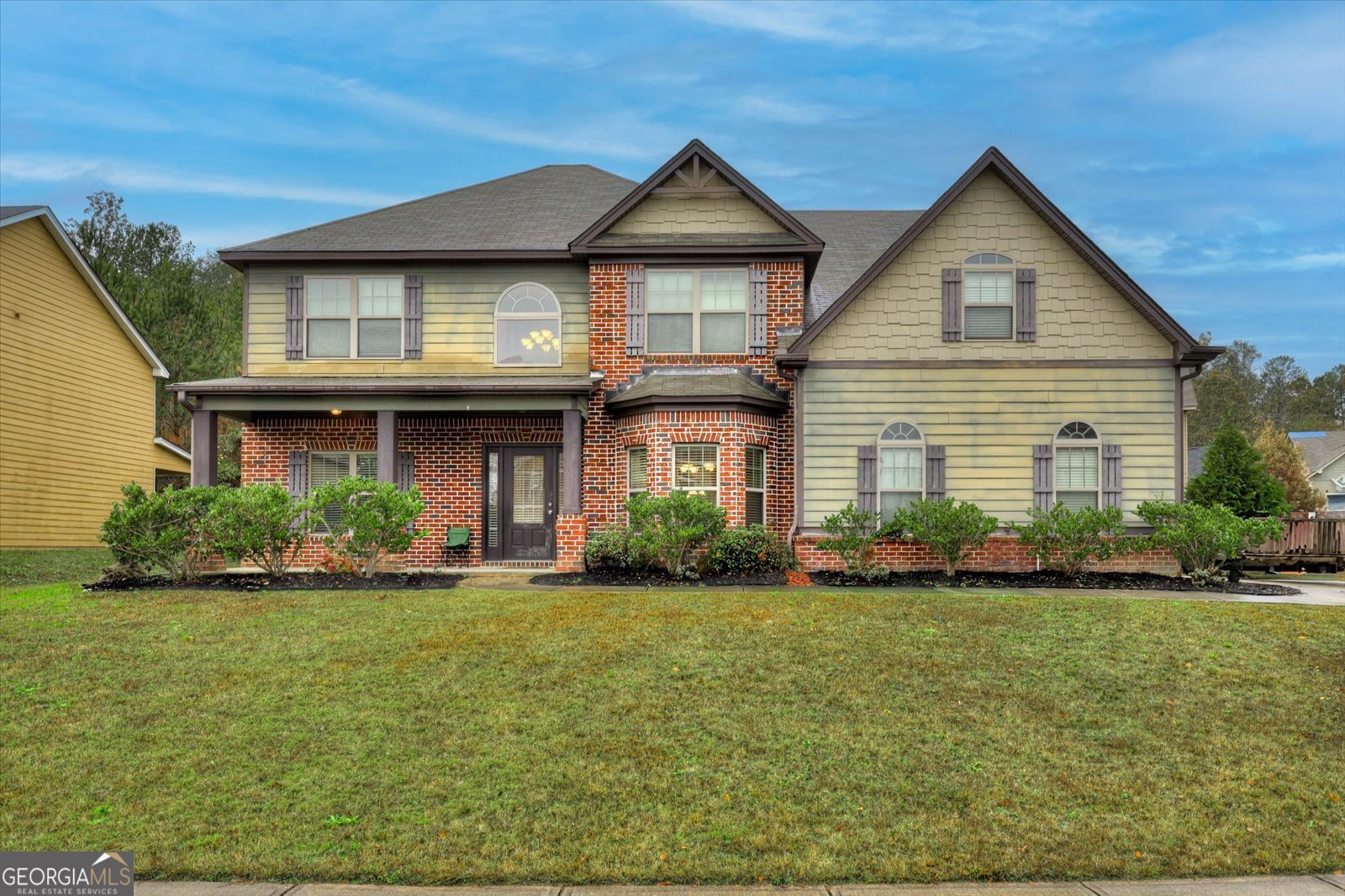 a front view of a house with a yard