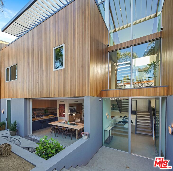 a front view of a house with outdoor seating