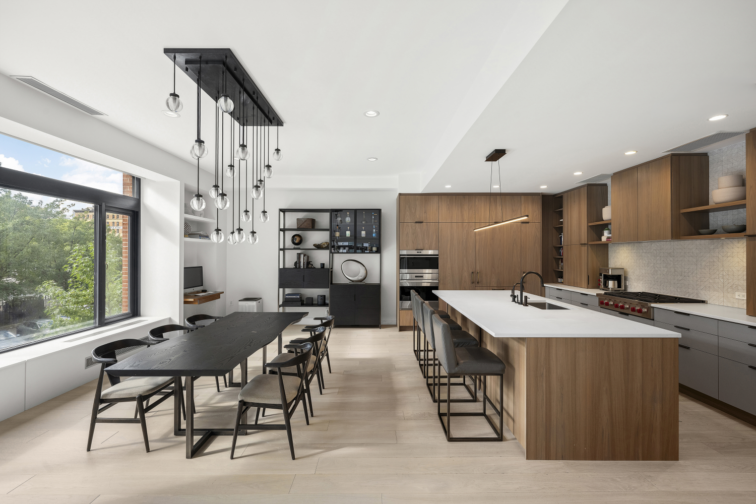 a kitchen with stainless steel appliances a table and chairs in it