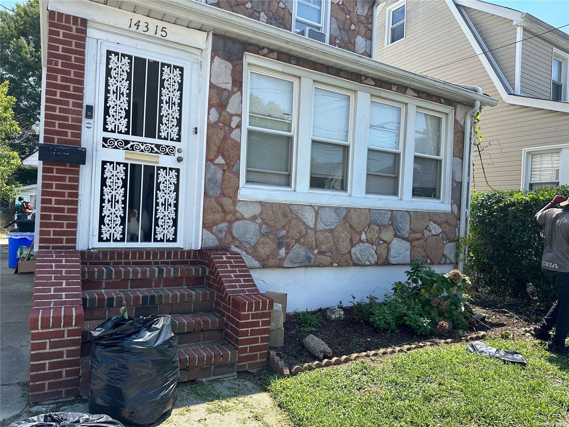 a view of a brick house with a large windows