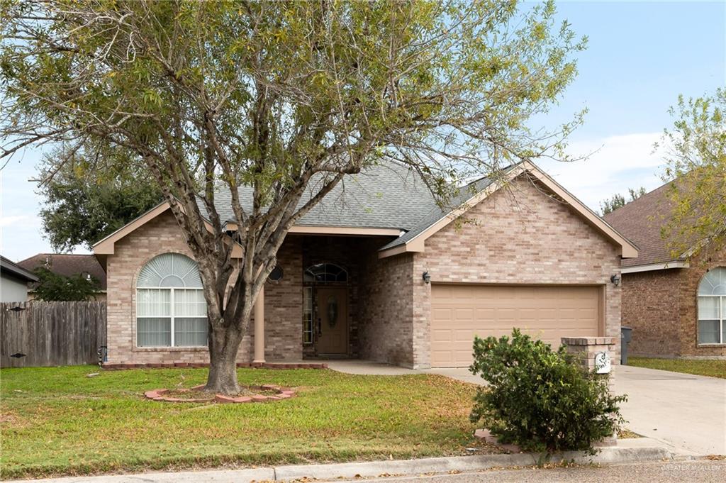 Ranch-style house with a front lawn and a garage