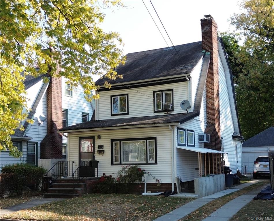 View of front of property with cooling unit