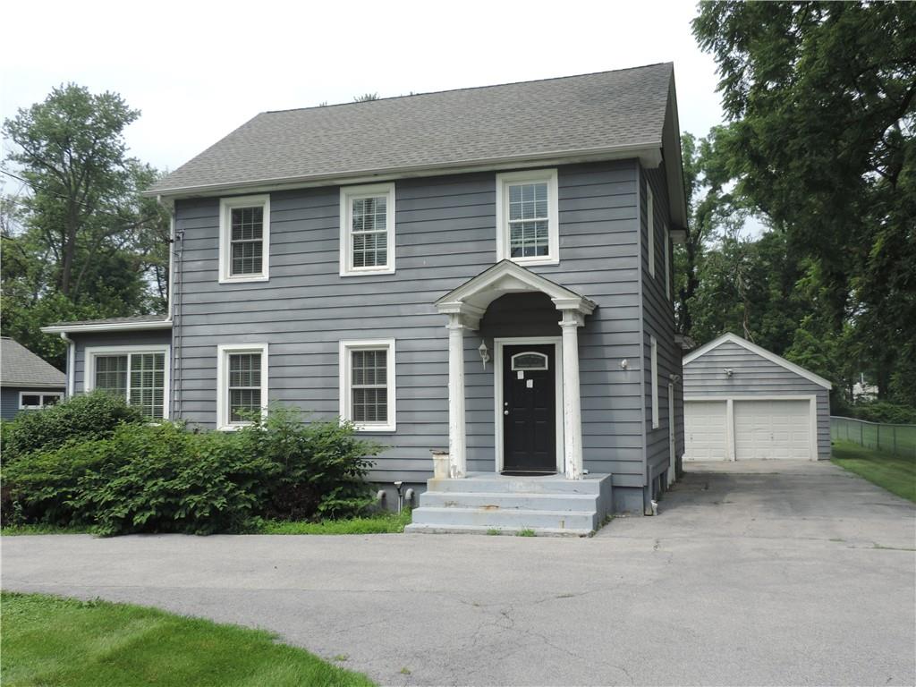 Colonial house with a garage and an outbuilding