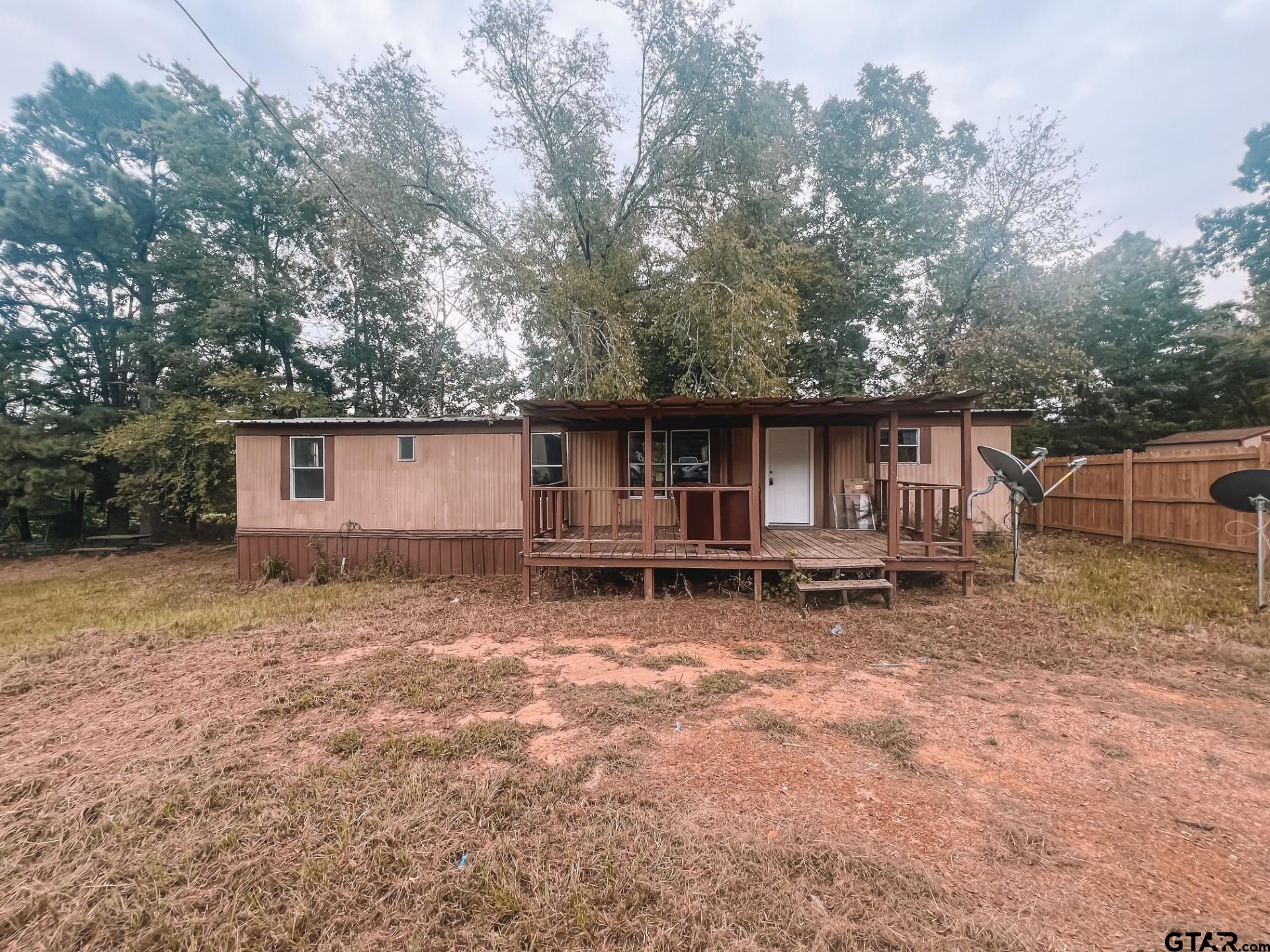 a view of a house with backyard and chairs