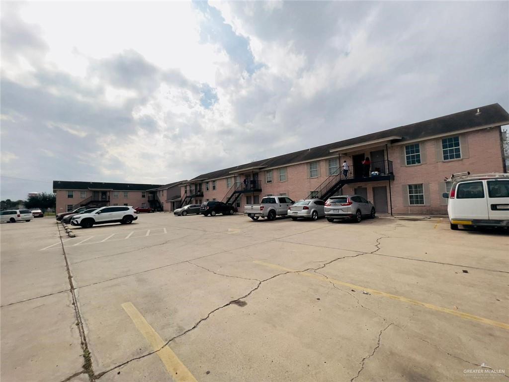 View of parking and apartment building