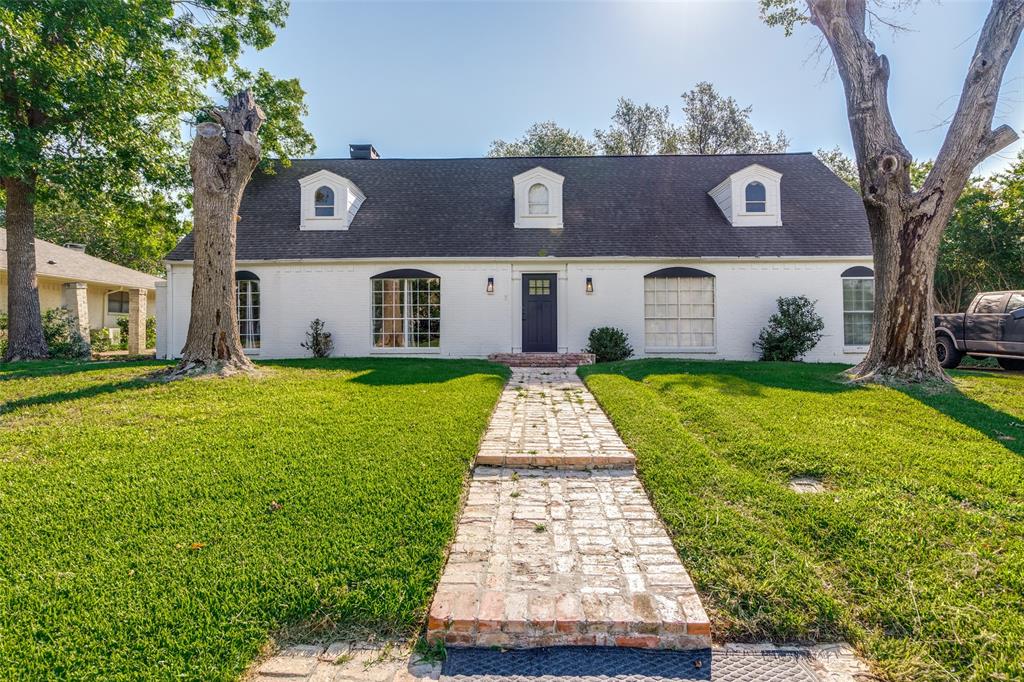 a front view of house with yard and green space