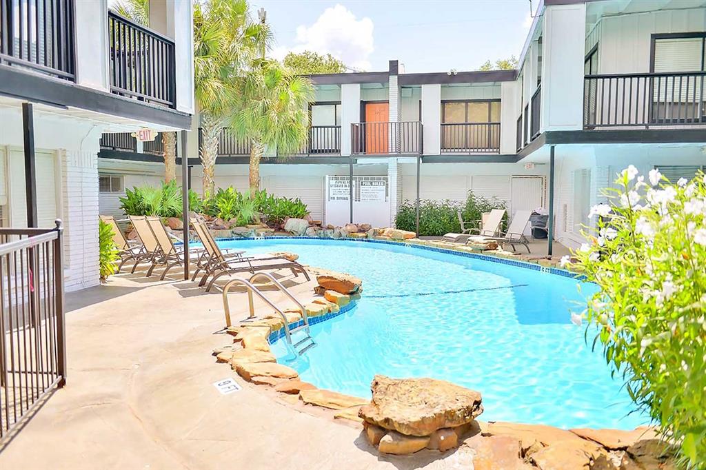 a view of a swimming pool with an outdoor seating