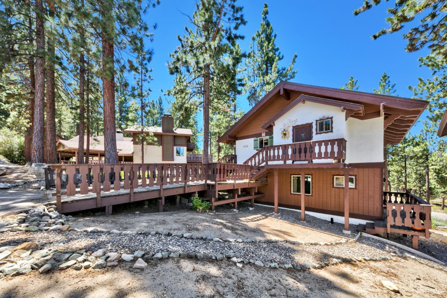 a view of a house with a yard and sitting area