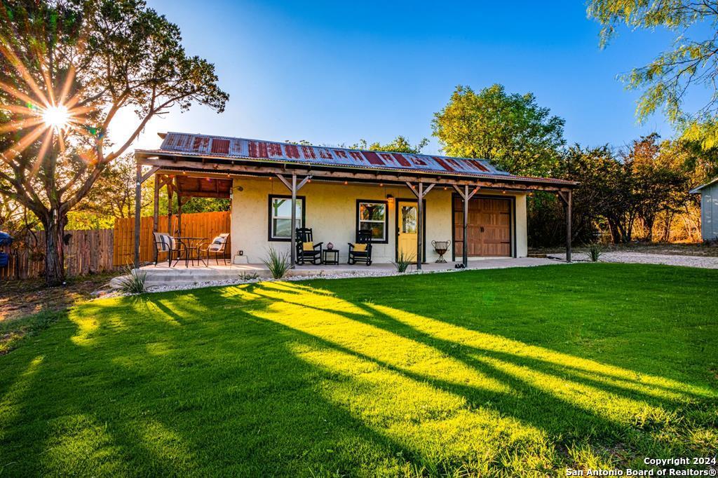 a view of a house with a yard patio and swimming pool