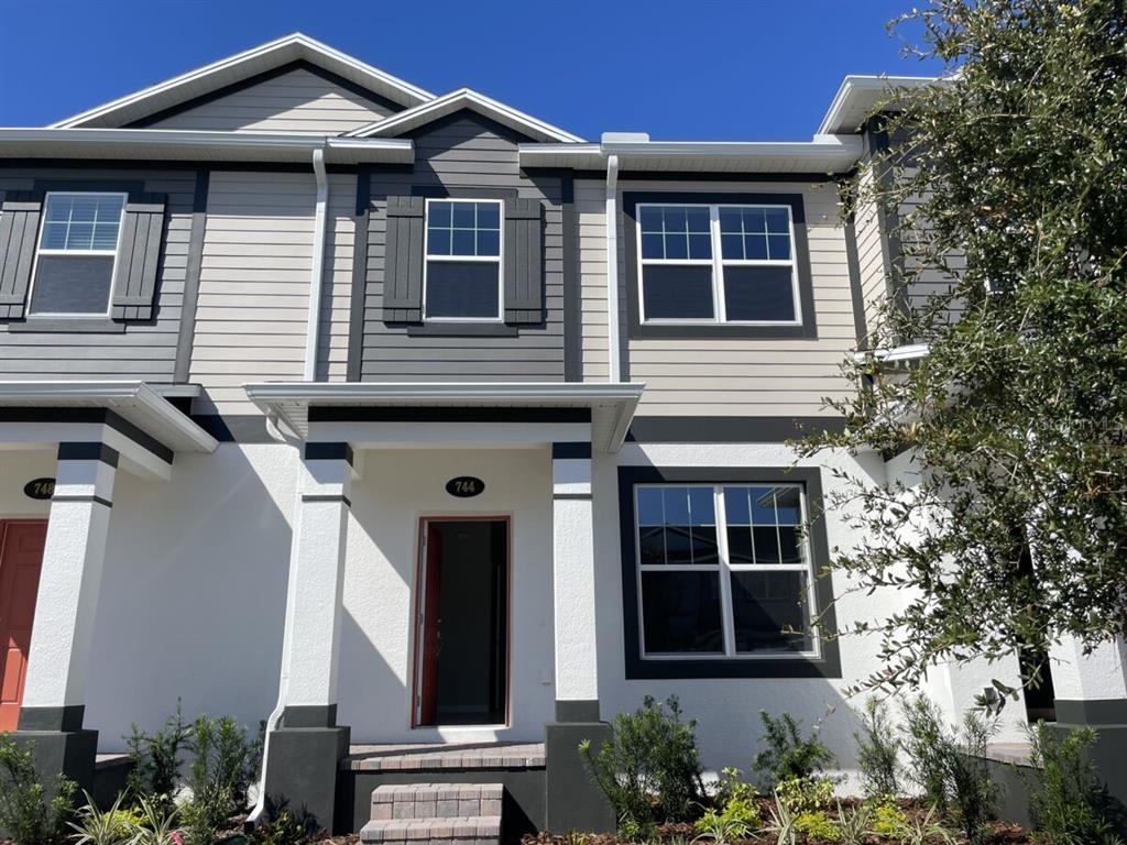 a front view of a house with a yard