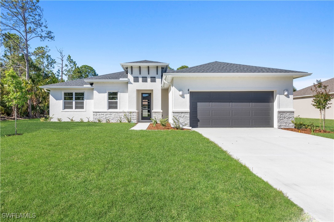 a front view of a house with a yard and garage