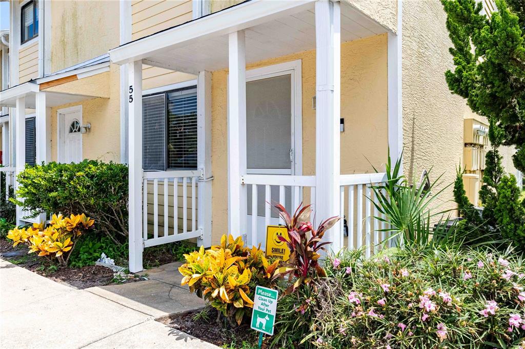 front of a house with potted plants