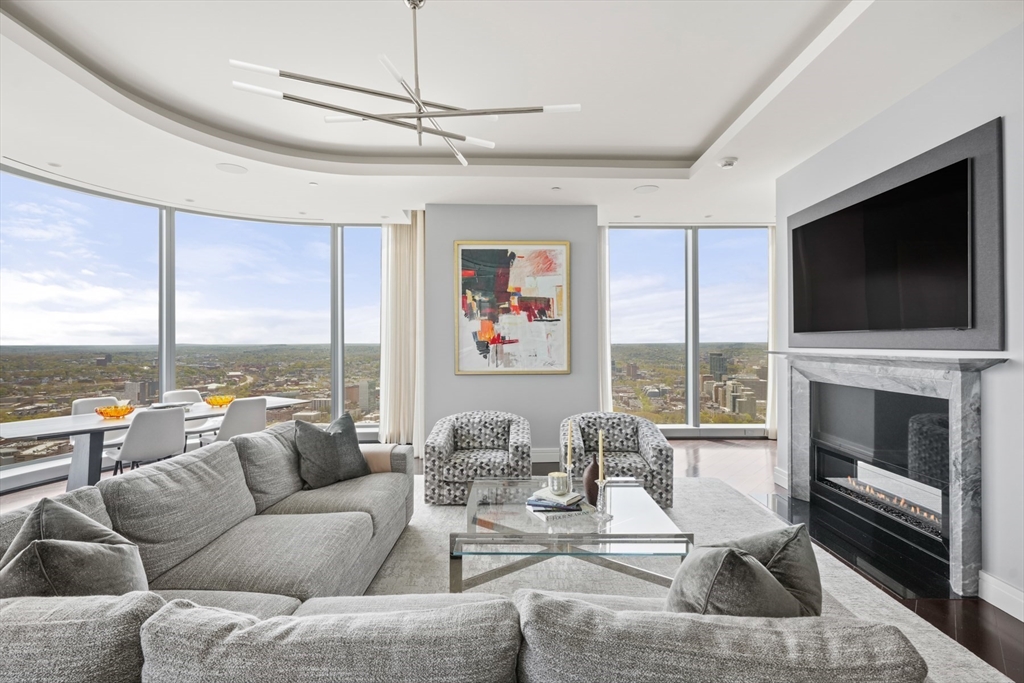 a living room with fireplace furniture and a flat screen tv