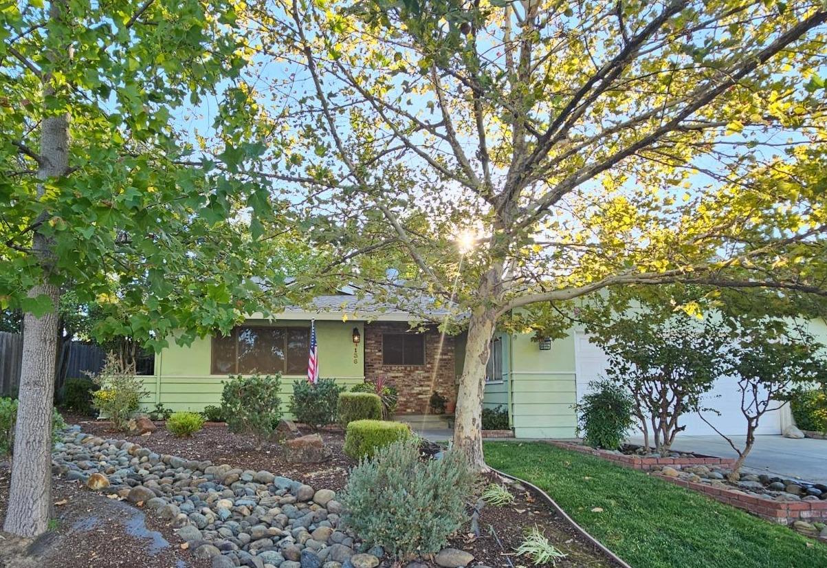 a front view of a house with a garden