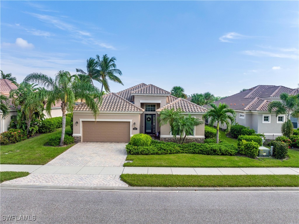 a front view of a house with a yard and garage