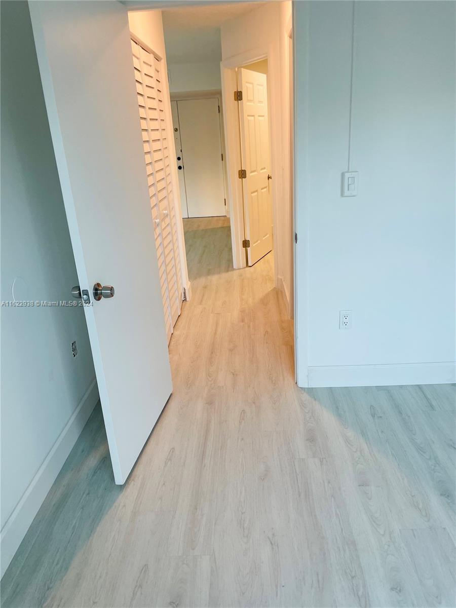 a view of hallway with wooden floor