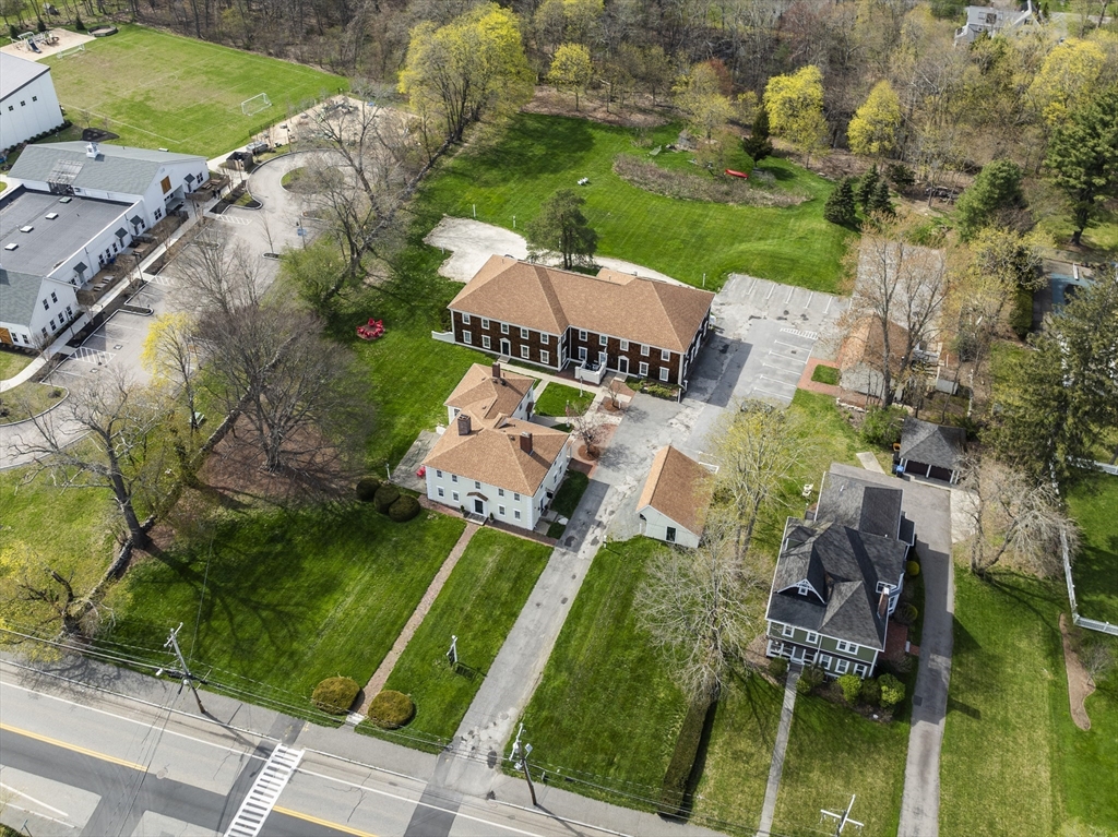 an aerial view of a house with garden space and street view