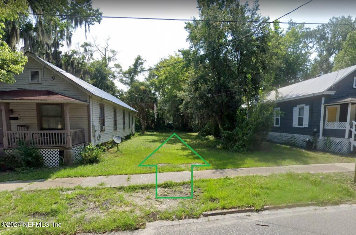 a backyard of a house with yard and outdoor seating