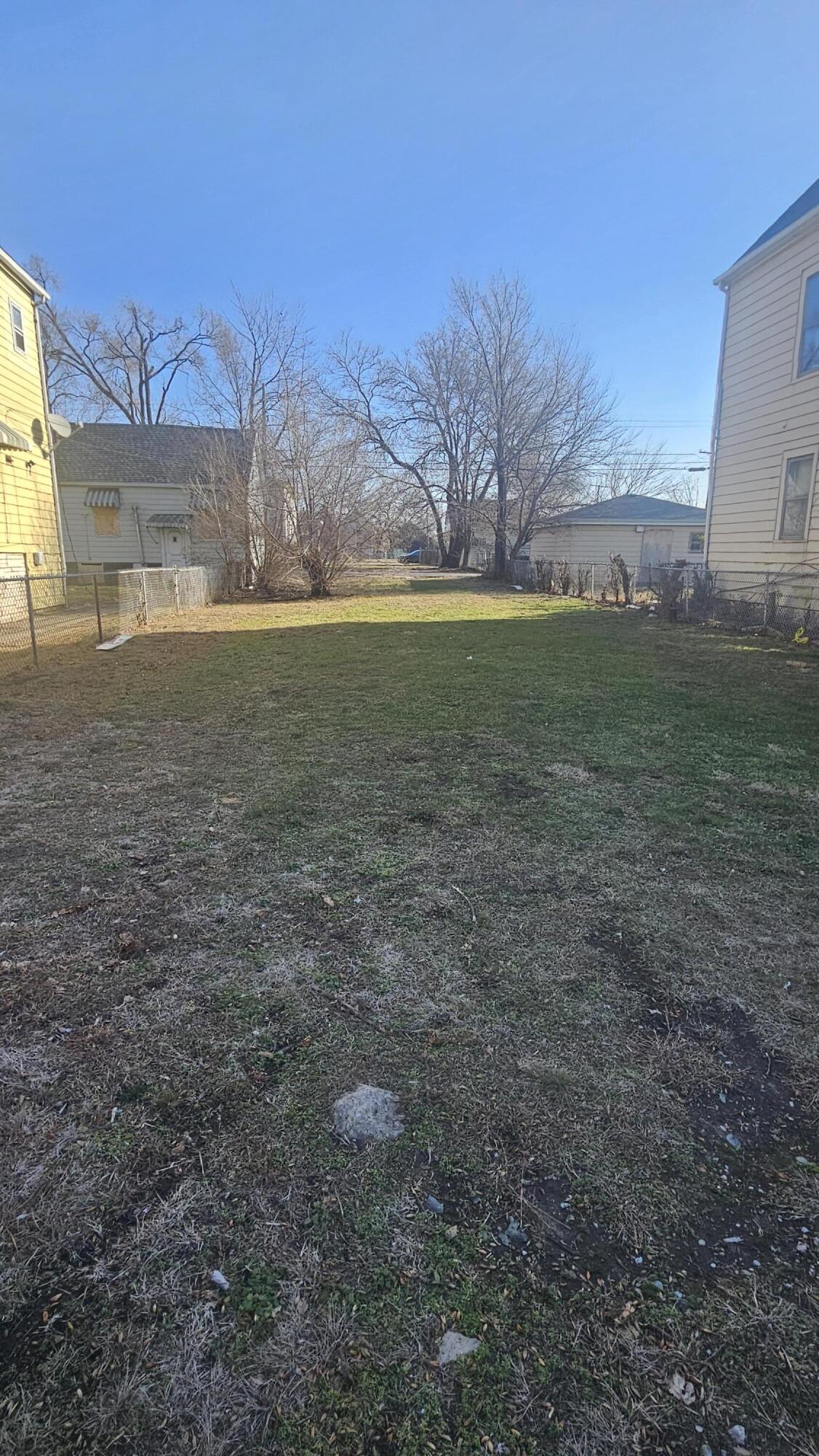 a view of yard with green space and house in the background