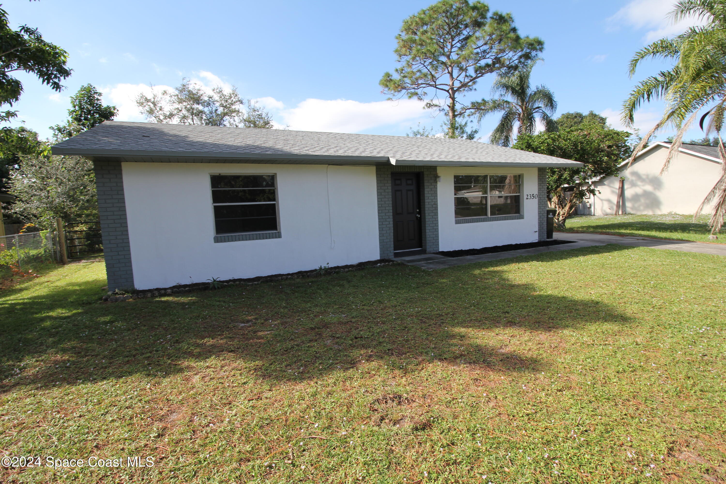 a front view of a house with yard and garage