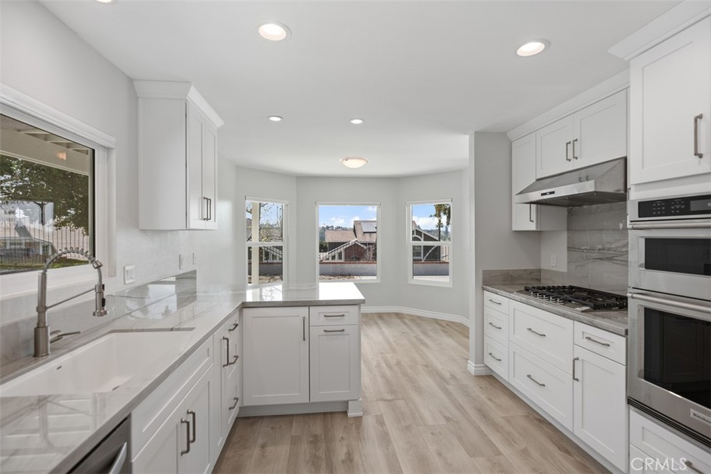 a kitchen with a sink stove and cabinets