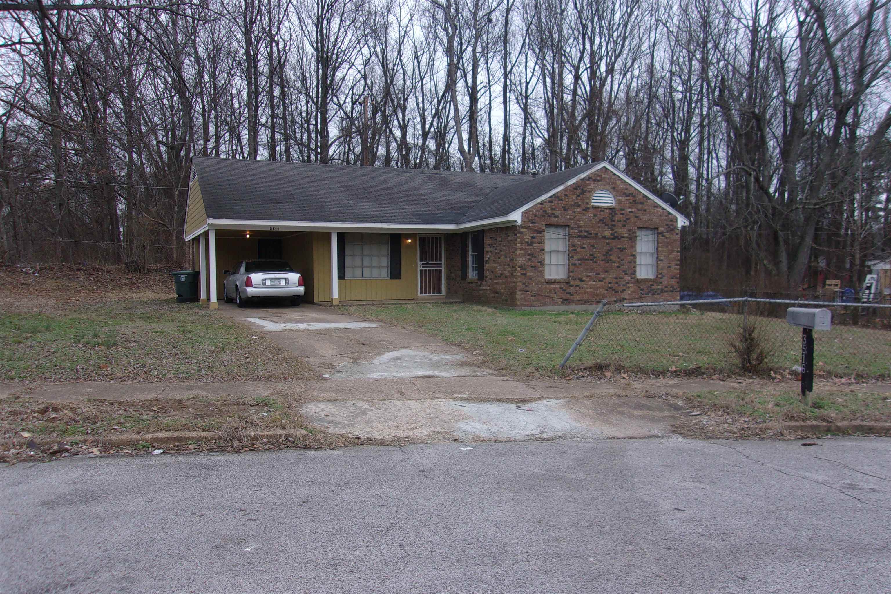 a front view of a house with yard and tree s