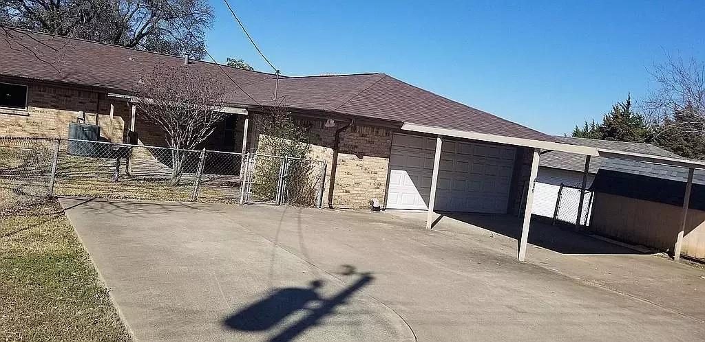 a backyard of a house with table and chairs