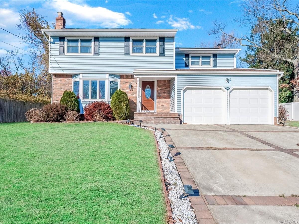 View of front of home featuring a garage and a front yard