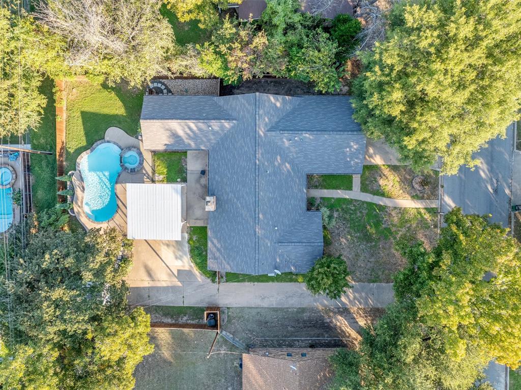 an aerial view of a house with a yard and garden