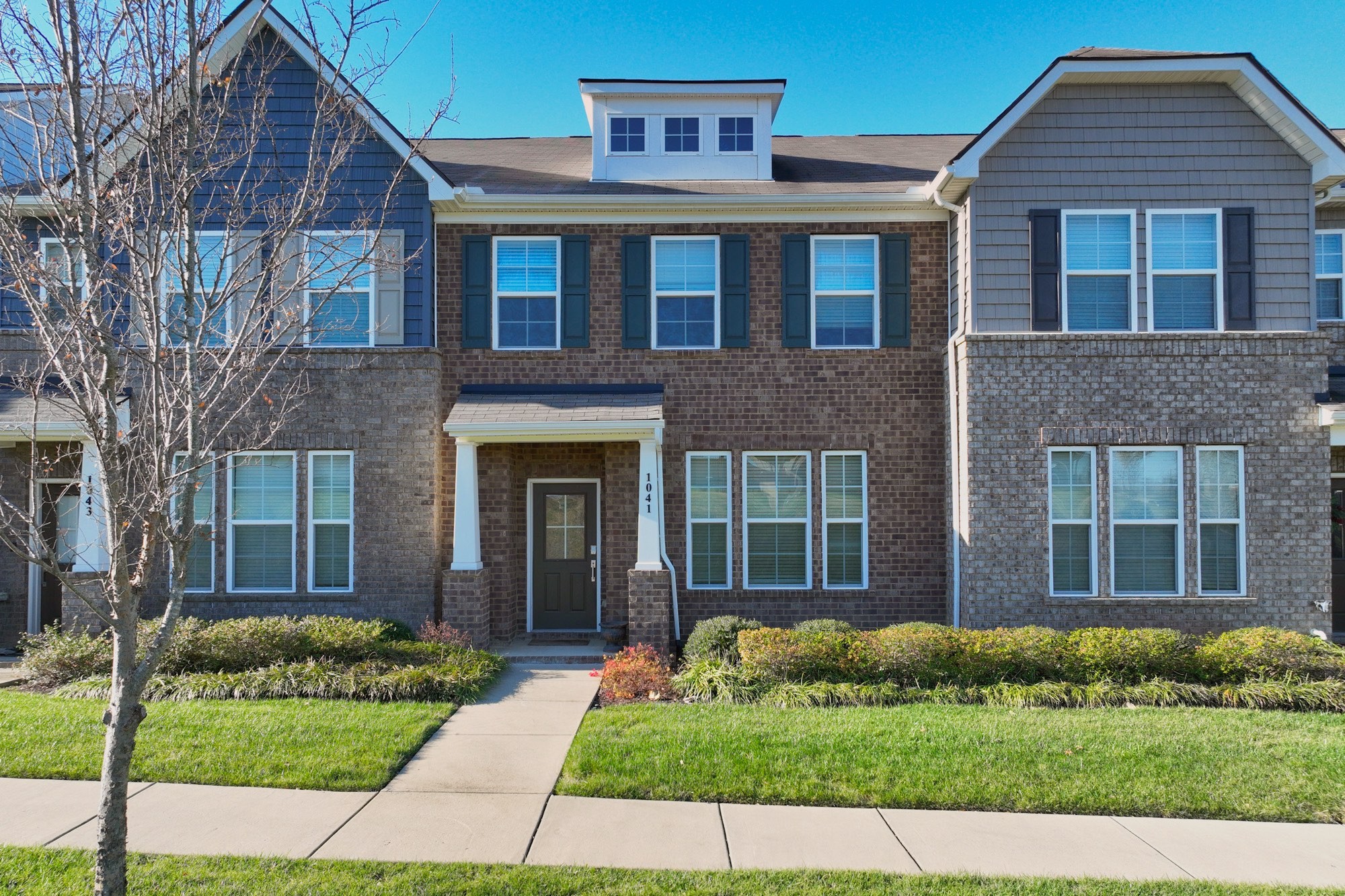 a front view of a house with a yard