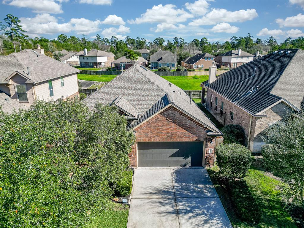 an aerial view of a house with a garden and lake view